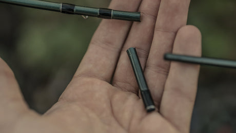 Close up view of a broken fly fishing rod in an open hand palm up